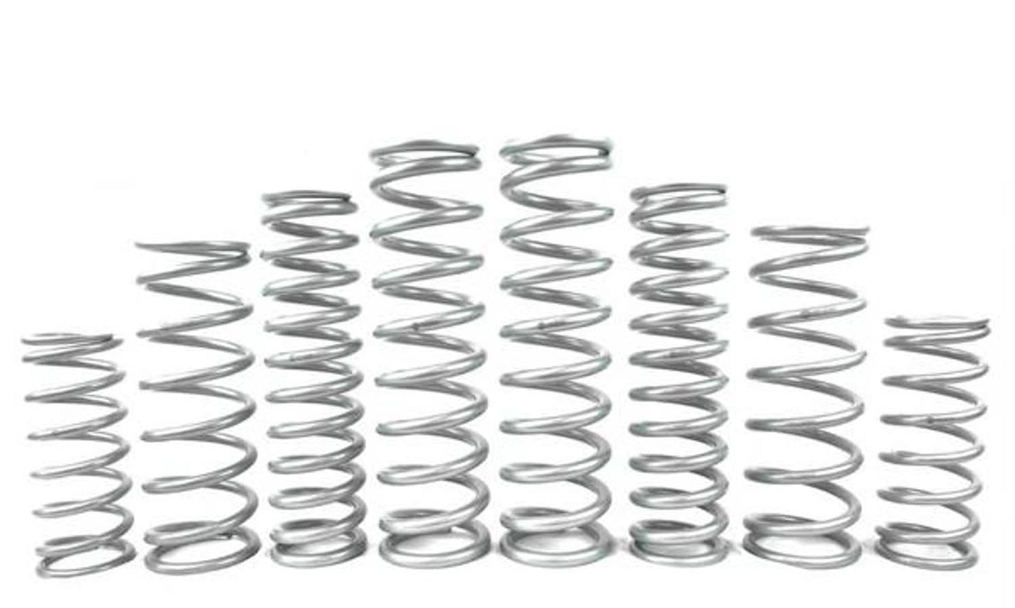 Various metal springs arranged in a row, showcasing different sizes for UTV suspension systems.