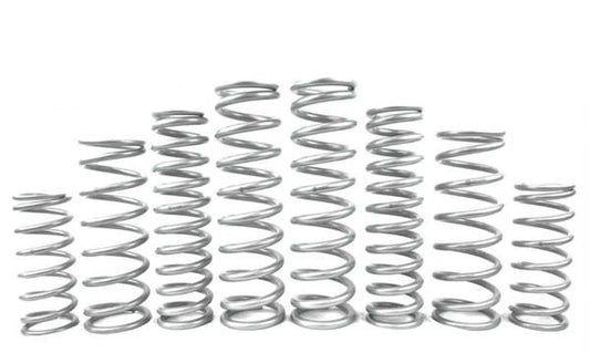 Various metal springs arranged in a row, showcasing different sizes for UTV suspension systems.