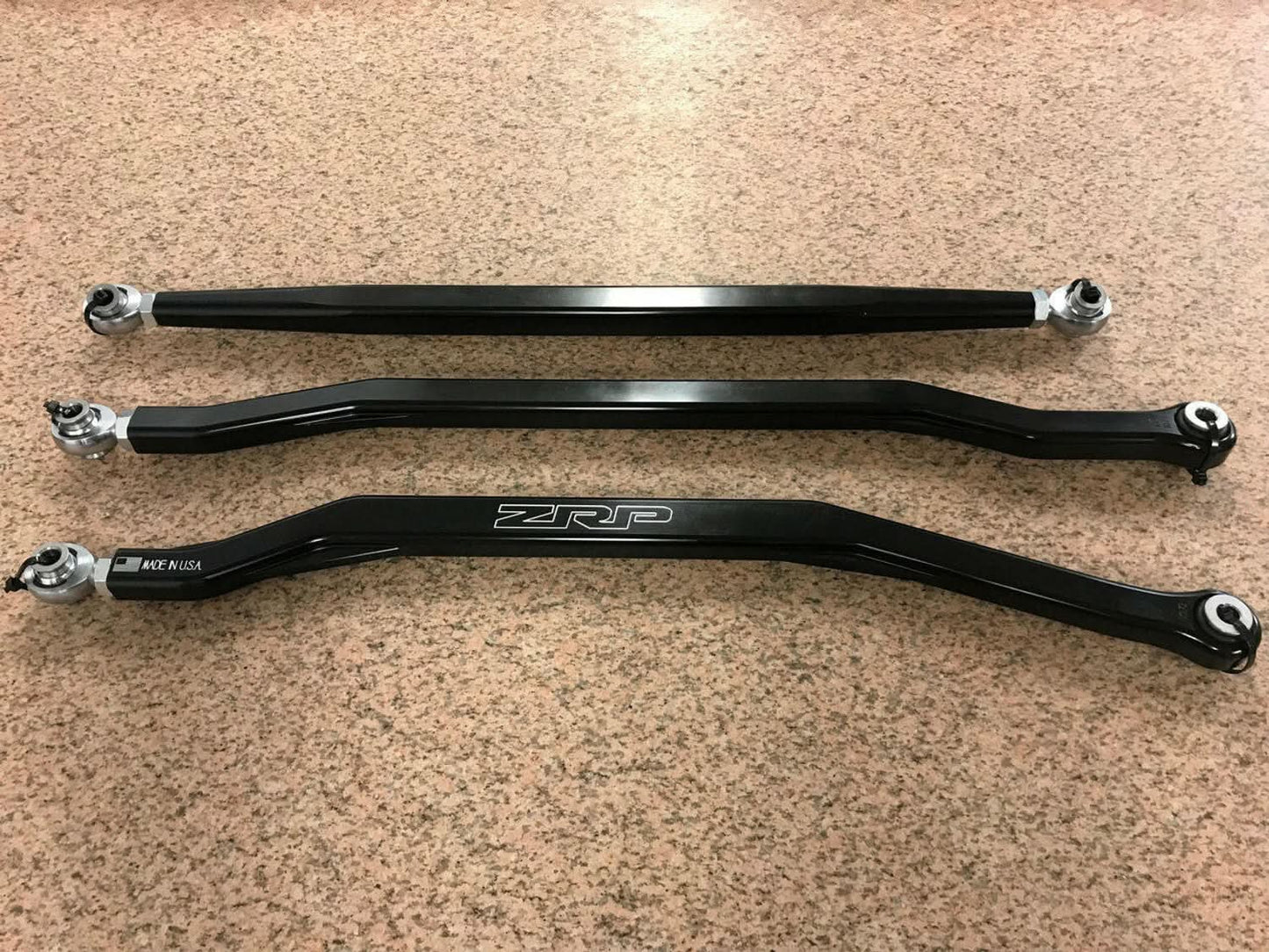 Three black hex rear radius rods for Can-Am Maverick X3, showcasing strength and precision engineering.