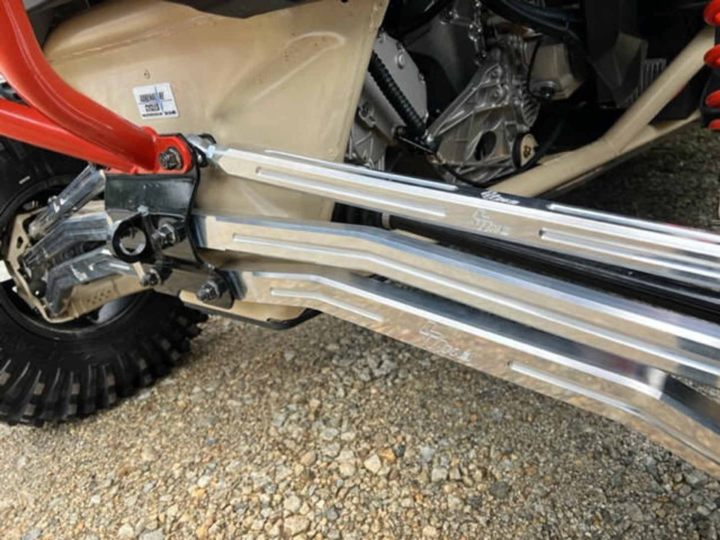 Close-up of L&W Fab adjustable radius rods installed on a Can-Am Maverick X3, showcasing performance and durability components.