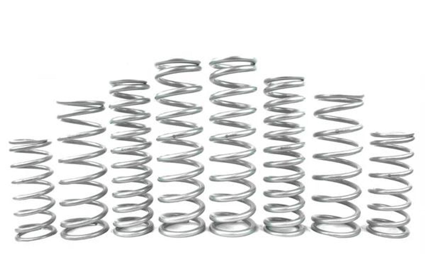 Various metal springs arranged in a row, showcasing different sizes for UTV suspension systems.