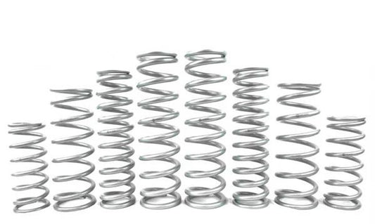 Various metal springs arranged in a row, showcasing different sizes for UTV suspension systems.