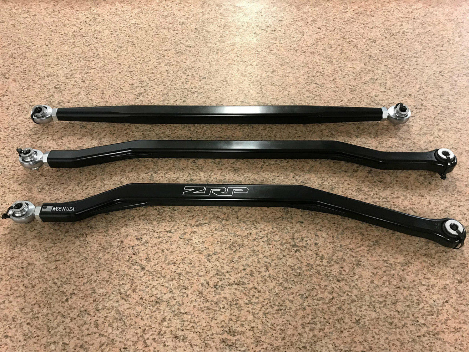 Three black hex rear radius rods for Can-Am Maverick X3, showcasing strength and precision engineering.